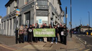Campaigners holding a banner outside the Glamorgan Public House, East Croydon
